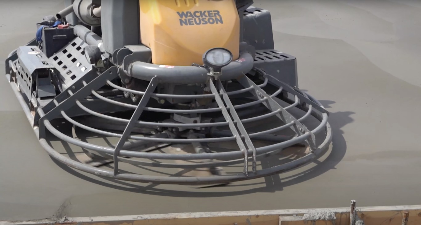 Professional concrete finishing equipment smoothing fresh slab in Bloomington, IL